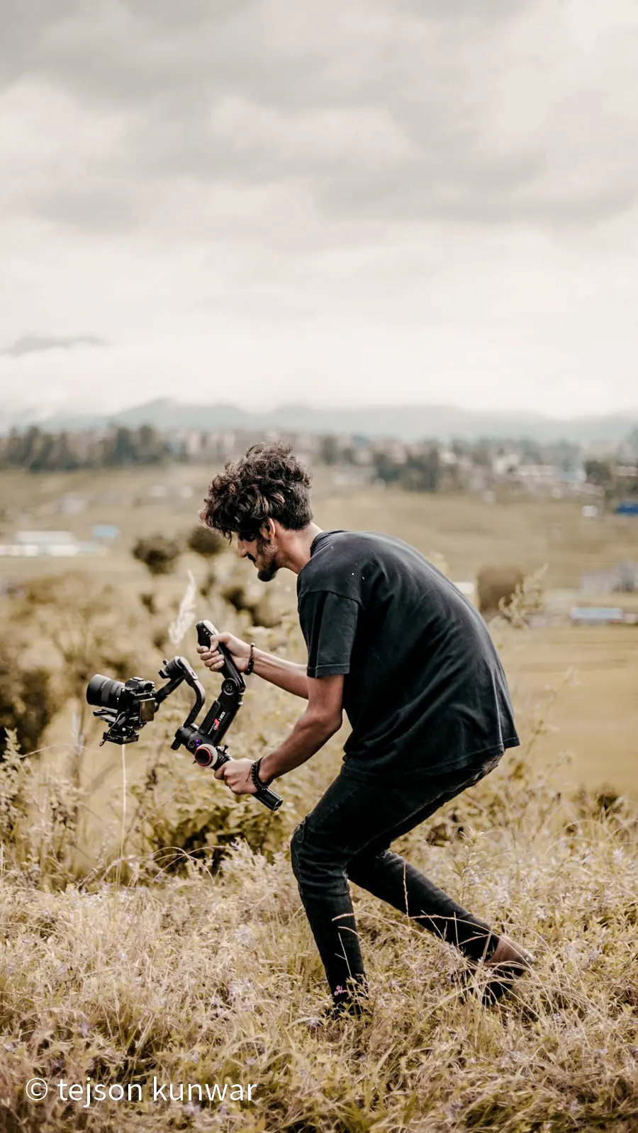 Tejson working with a camera on location