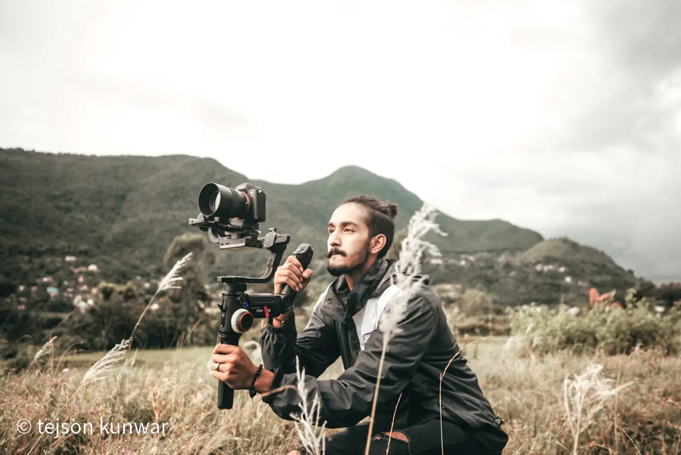 Tejson filming outdoors with a handheld camera