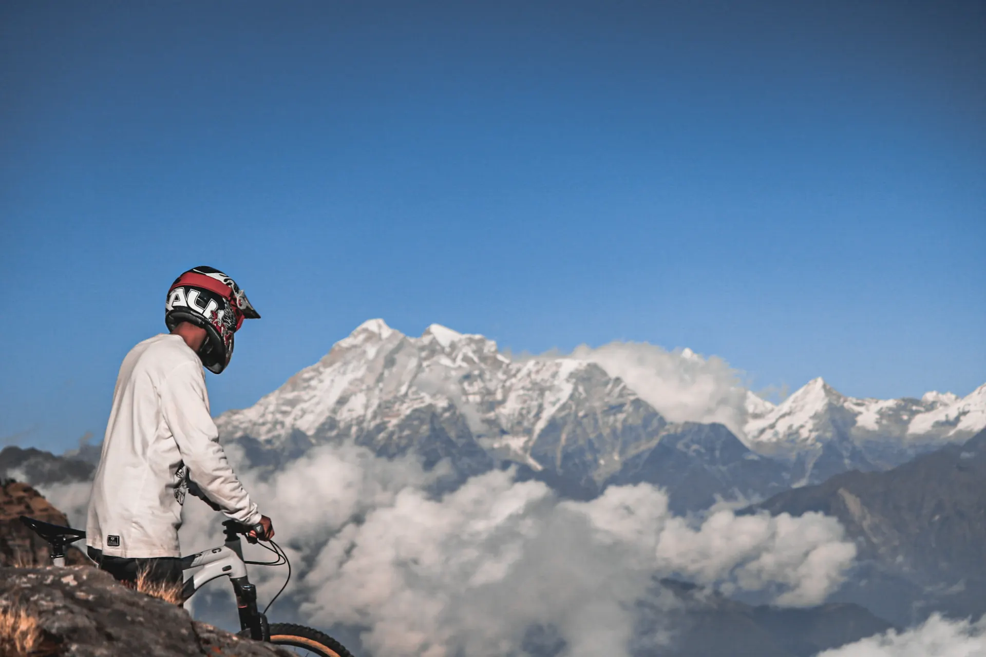 Rider with a mountain bike looking toward the Himalayas