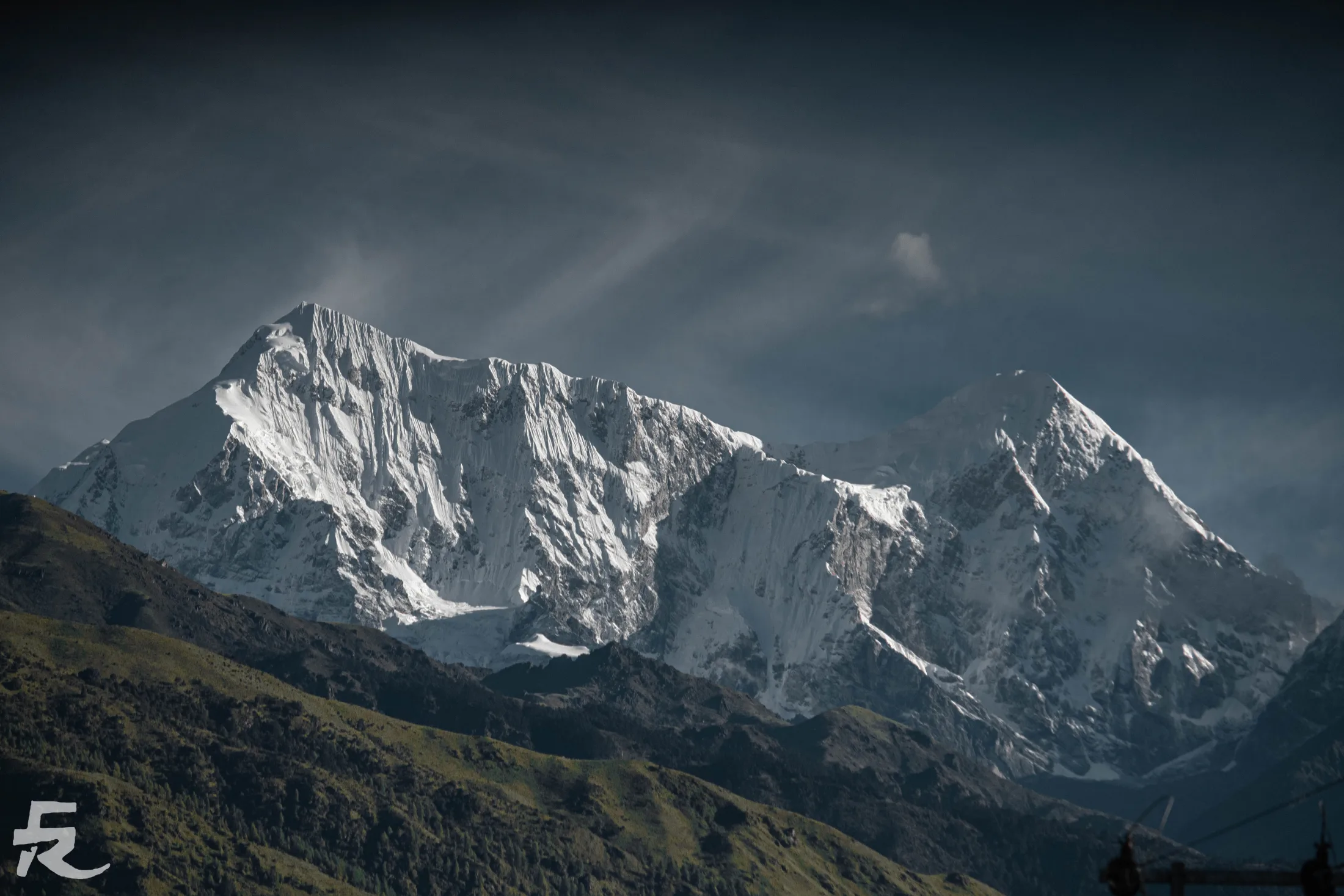 A dramatic Himalayan peak beneath a gathering sky