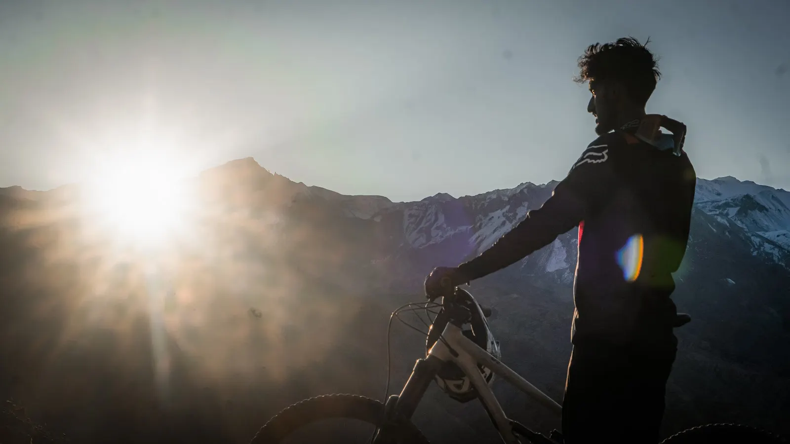 Rider with a mountain bike at sunset in Nepal