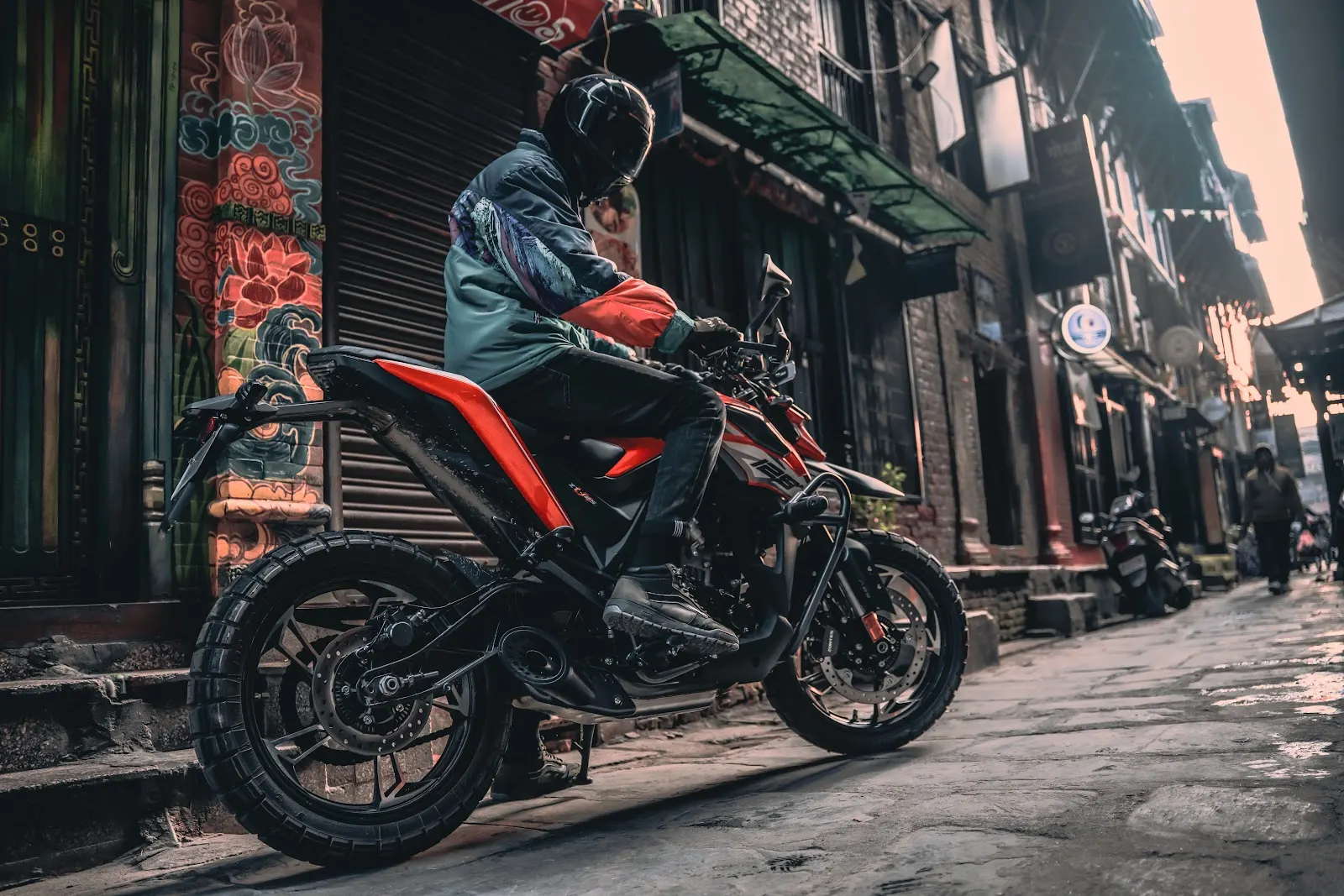 Motorbike and rider in a historic street