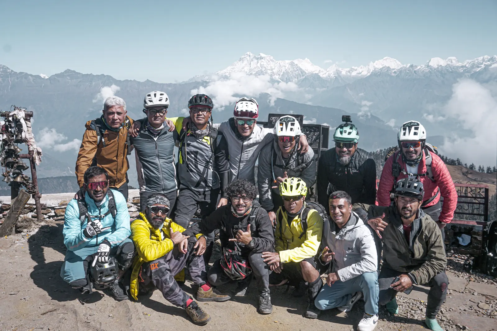 Mountain bikers together beneath the Himalayan range