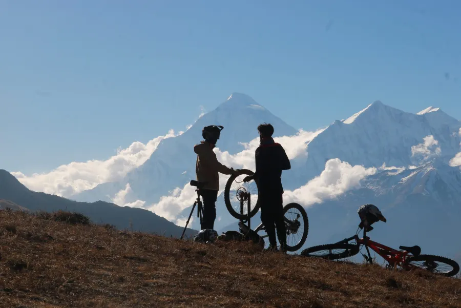 Rider with headlamp near a false summit